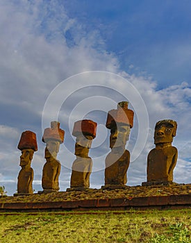 Moai on Easter Island with red topknot hats at Anakena Ahu