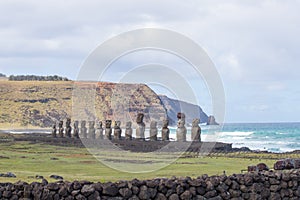 The  moais of Ahu Tongariki and the wild coast of Easter Island. Easter Island, Chile