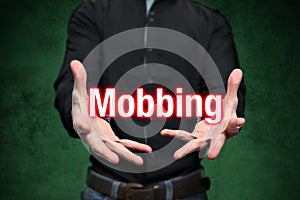 Mobbing, bullying, man holds lettering in the hands