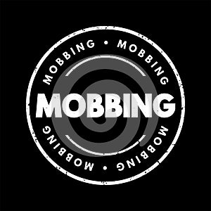 Mobbing - sociological term, means bullying of an individual by a group, text concept stamp