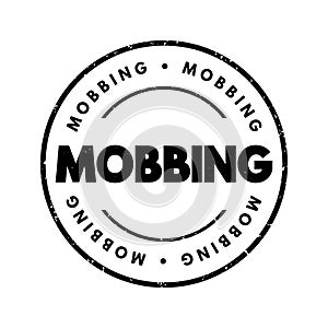 Mobbing - sociological term, means bullying of an individual by a group, text concept stamp photo