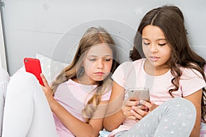 Mobile addicted. Girl play games smartphone online. Pajamas party concept. Happy childhood. Kids surfing internet mobile