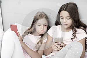 Mobile addicted. Girl play games smartphone online. Pajamas party concept. Happy childhood. Kids surfing internet mobile