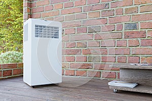 Mobile air conditioner in a brick room with a window 3d