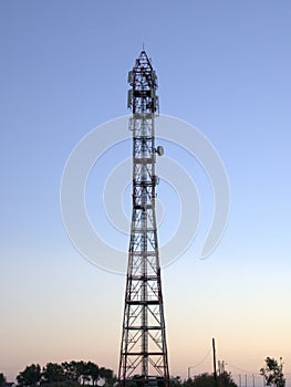 Mobile antenna mast structure at sunset blue sky