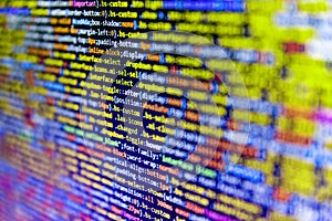 Mobile app developer. Web site codes on computer monitor. Screenshot with random parts of program code. Closeup developing