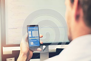 Mobile app development - smart phone with application wireframe