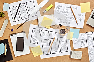 Mobile app wireframe sketches over UX designers desk