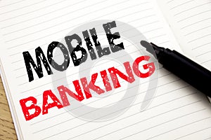 Mobile Banking. Business concept for Internet Banking e-bank written on notebook with copy space on book background with marker pe