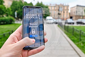 Mobile banking interface with secure payment function in smartphone and holding by hand