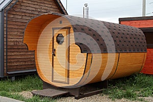 Mobile bath in the form of a wooden barrel.