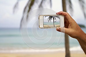 Mobile cell phone screen photography of a beach