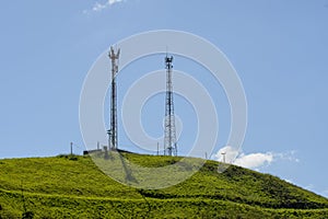 Mobile cell tower in open field with blue sky