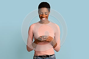 Mobile Communication. Happy Black Female Using Modern Smartphone For Messaging With Friends