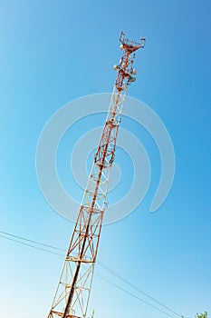 Mobile communication network communication tower with antens on the background of the sky