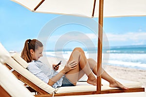 Mobile Communication. Woman Using Phone, Dialing Number On Beach