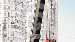 Mobile construction crane on construction site. Tower crane jib with steel cable winch
