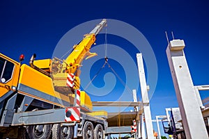 Mobile crane is carry concrete joist to assembly huge hall