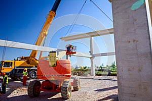 Mobile crane is carry concrete joist to assembly huge hall