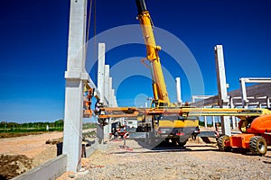 Mobile crane is carry concrete joist to assembly huge hall