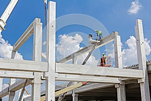 Mobile crane is carry concrete joist to assembly huge hall.