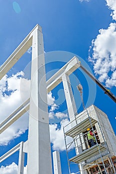 Mobile crane is operating to assembly concrete joist on new edif