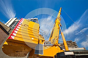 Mobile crane at work at downtown construction site