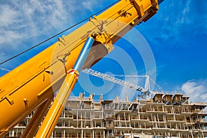 Mobile crane at work at downtown construction site