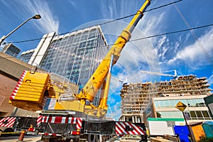 Mobile crane at work at downtown construction site