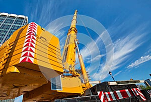 Mobile crane at work at downtown construction site