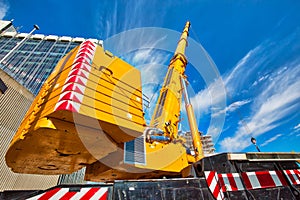 Mobile crane at work at downtown construction site