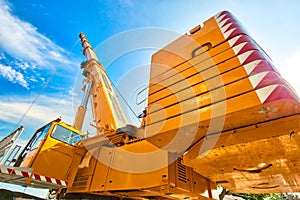 Mobile crane at work at downtown construction site