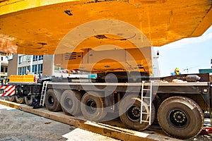 Mobile crane at work at downtown construction site