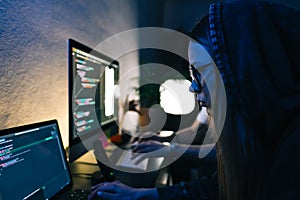 Mobile developers team writes program code on a computer, programmers work in home office