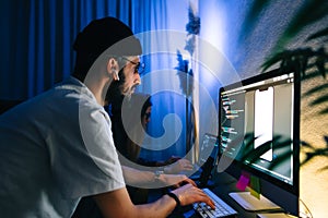Mobile developers team writes program code on a computer, programmers work in home office