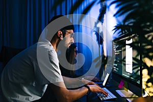 Mobile developers team writes program code on a computer, programmers work in home office
