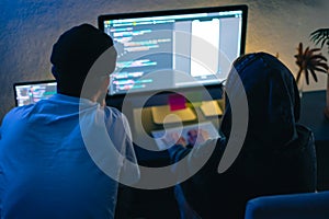 Mobile developers team writes program code on a computer, programmers work in home office