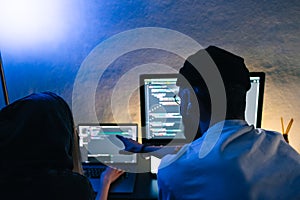 Mobile developers team writes program code on a computer, programmers work in home office