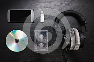 Mobile device, CD, cassette, USB flash drive, studio headphones