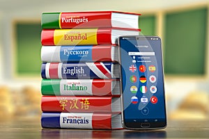 Mobile dictionary, translator  and e-learning.concept . Learning languages online.  Smartphone and books with language courses