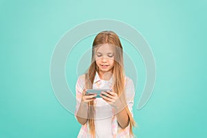 Mobile gadget dependence. Girl small child smiling hold smartphone. Internet surfing and social networks. Problem of
