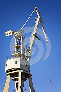 Mobile harbor cranes over blue sky. Transport and technology concept