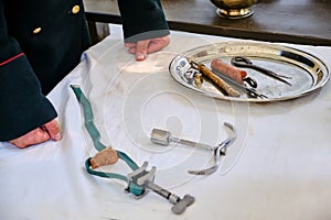 Mobile hospital, retro military medicine and surgeon`s hands. Vintage field medic tools 18th and 19th century