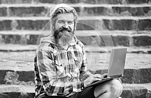 Mobile internet. Agile business. Bearded guy sit stairs background. Work and relax. Working online. Hipster inspired