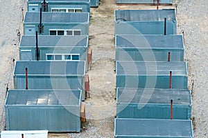 Mobile metal containers for the placement of a work crew on a construction site. A temporary residential town of builders. Simple