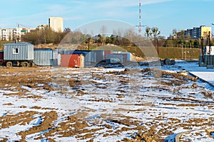 Mobile metal containers for the placement of a work crew on a construction site in winter. A temporary residential town of