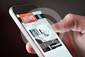 Mobile news application in smartphone. Man reading online news on website with cellphone. photo