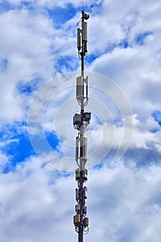 Mobile operator base station. Cellular antenna against the sky and clouds