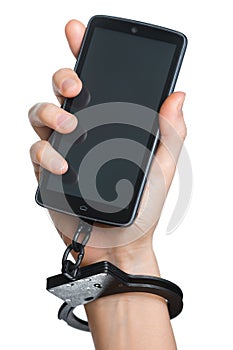 Mobile phone addiction concept. Smartphone and handcuff in hand