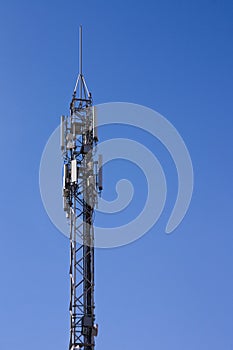 Mobile phone antenna with a clear blue sky in the background